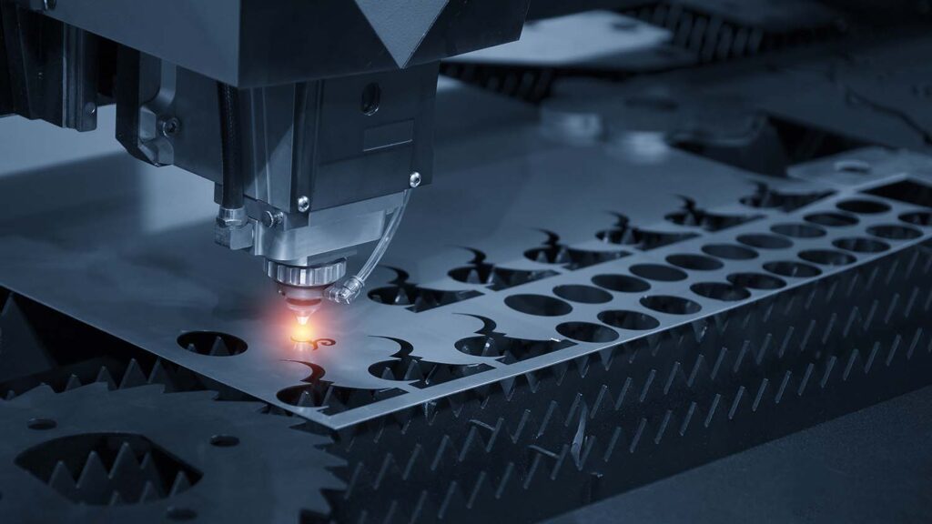 The CNC laser cut machine while cutting the sheet metal with the