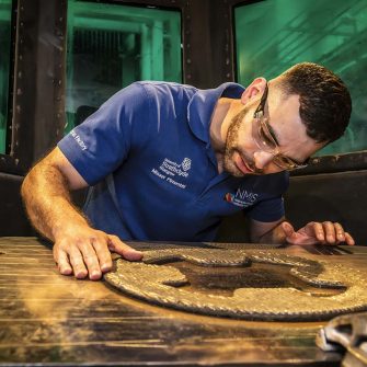 web image of NMIS Misael Pimentel inspecting a LFAM WAAM part for marine use copy